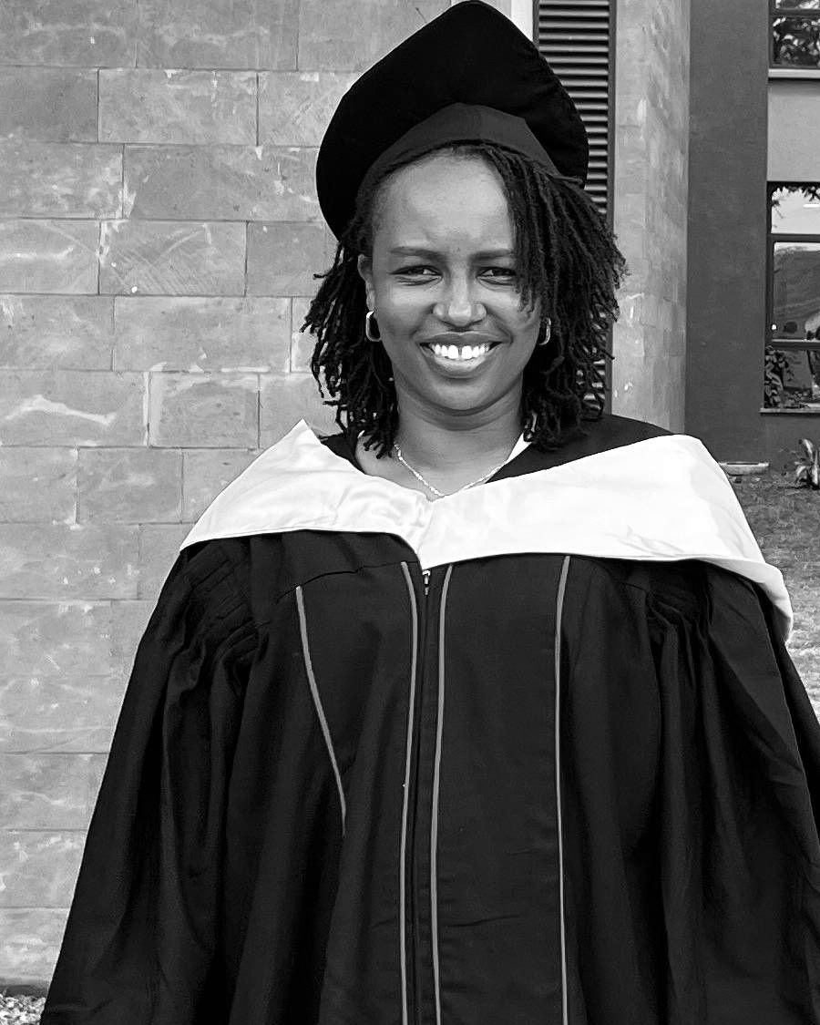 Grace Wanjũgũ Kamau, smiling, in graduation robes